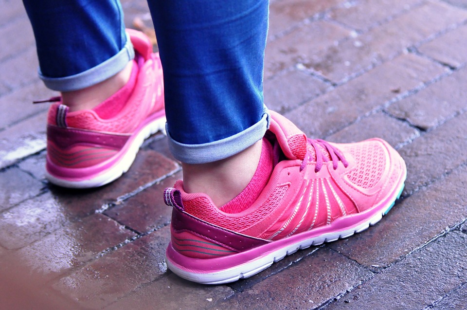 image of person standing with running shoes